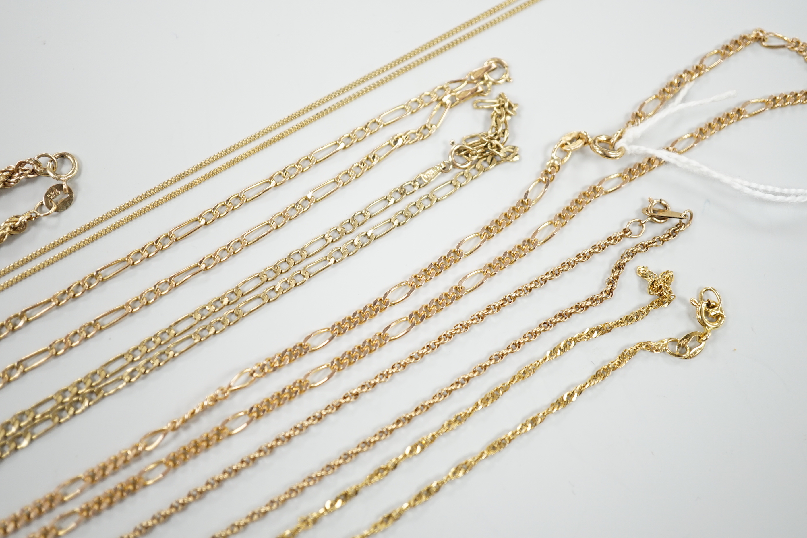 Six assorted modern 9ct gold chains, longest 54cm and a 9ct gold rope twist bracelet, 18cm, 18.5 grams.